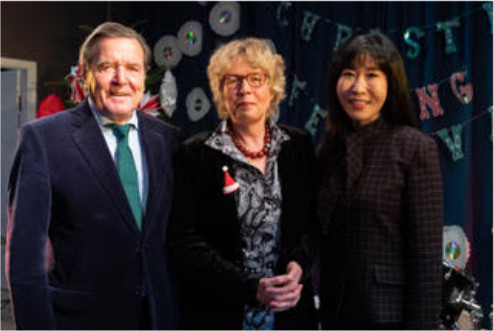 Gerhard Schröder neben Karin Haller, Schulleiterin der Peter-Ustinov-Schule und Soyeon Schröder-Kim (v.r.)